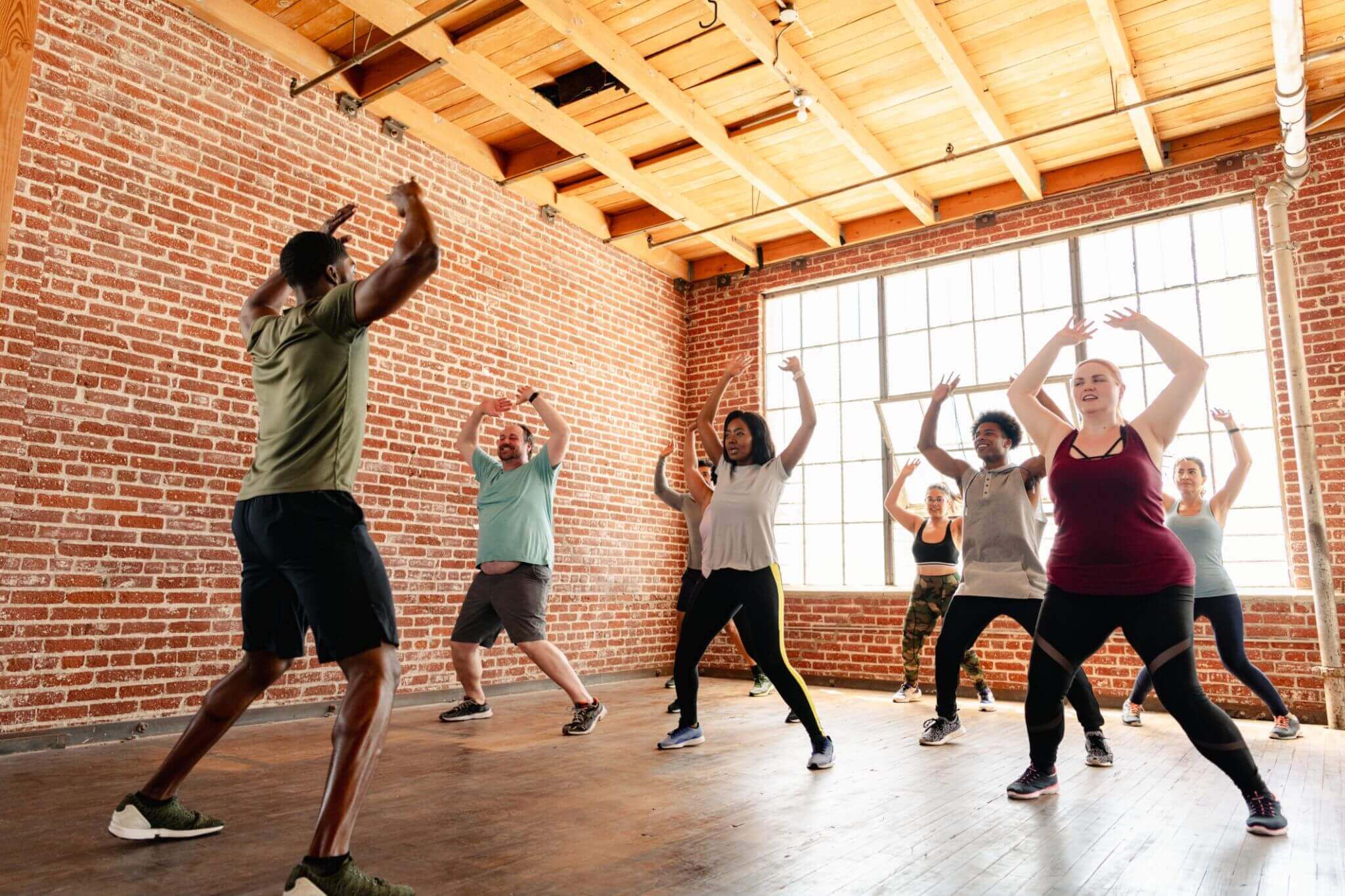 Group fitness class in a brick studio.