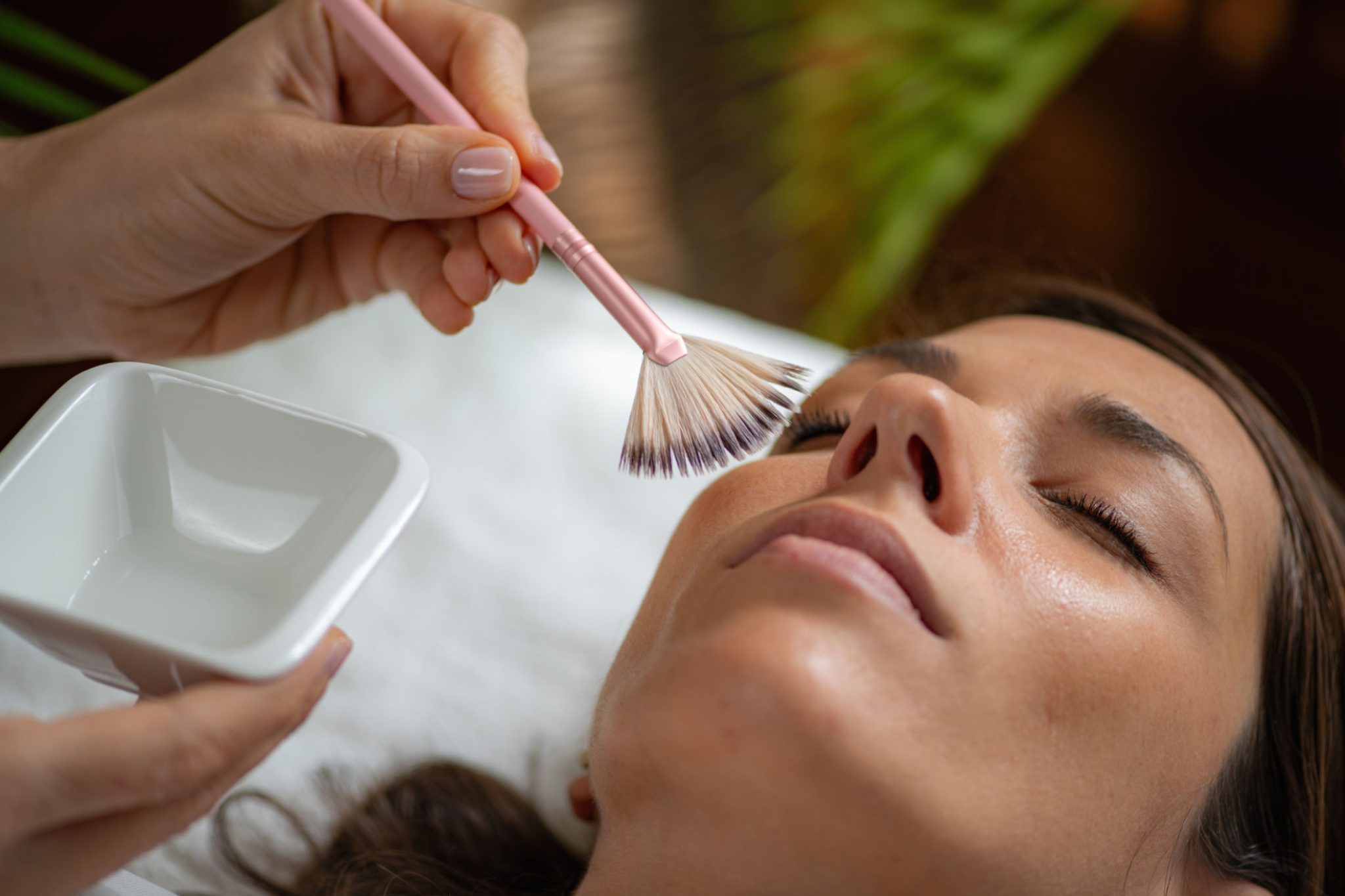 Facial treatment with brush and bowl.