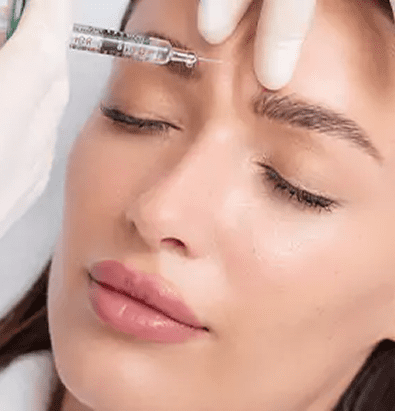Woman receiving a cosmetic eyebrow injection.