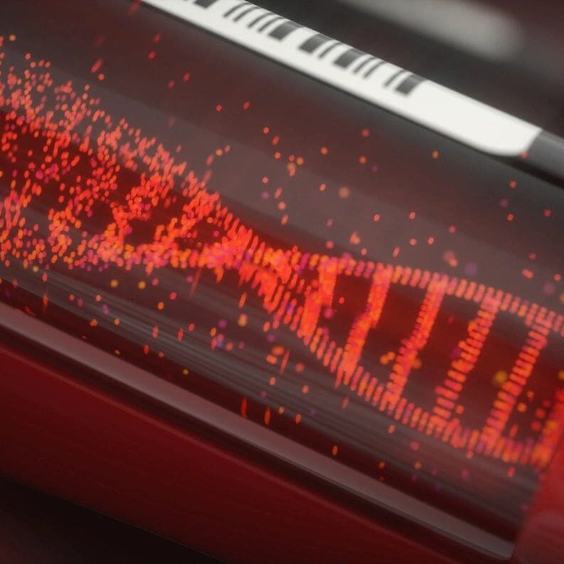 A glowing red DNA helix inside a transparent tube with a keyboard in the background.
