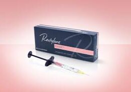 Perfection lip filler syringe with its box on a pink background.