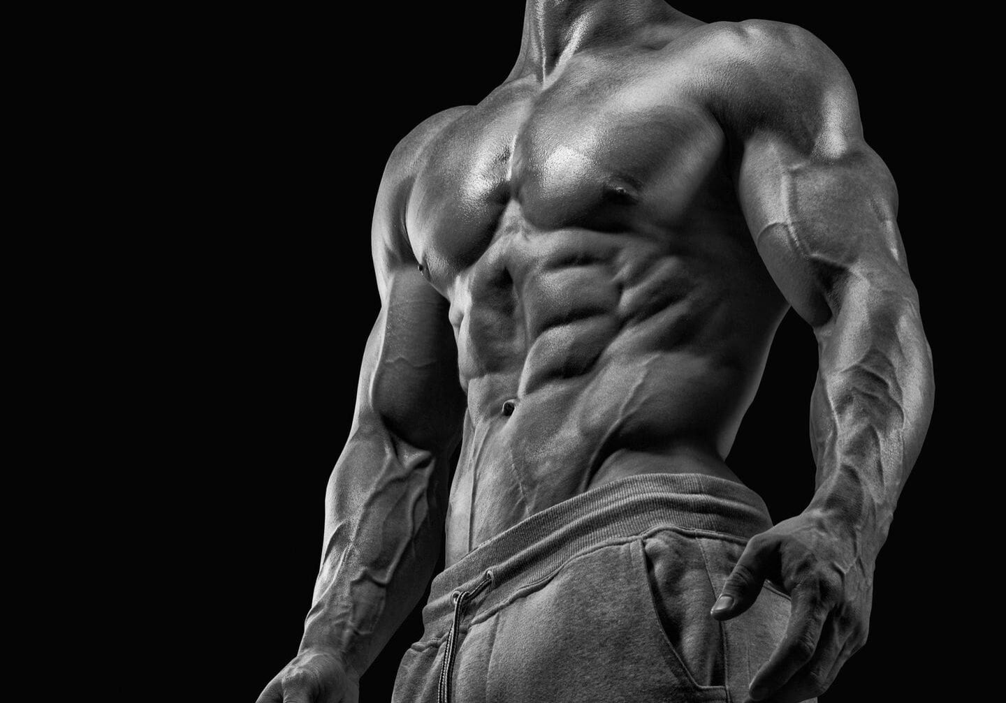 Muscular man posing in black and white.