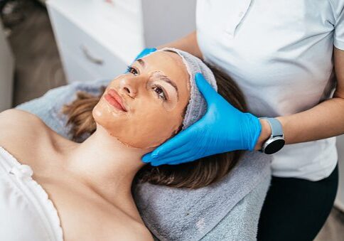 Woman receiving a facial treatment at a spa.